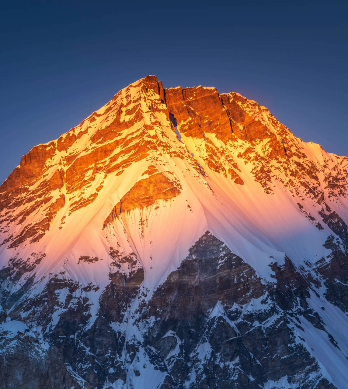 Mountain top bathed in a orange sunset