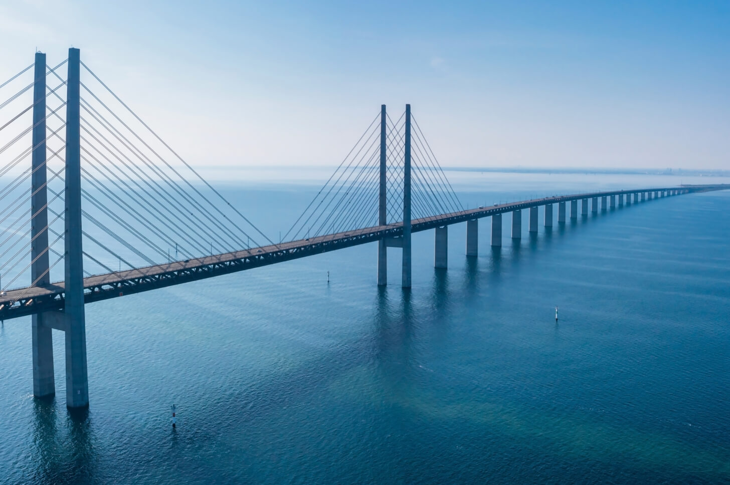 Suspension bridge crossing crystal blue water